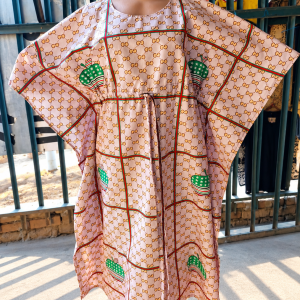 monogrammed kaftan in sunlit market setting